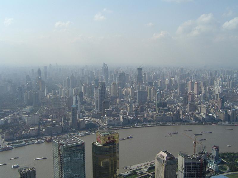 Aerial City View of China with Huge River and Assorted Buildings View. Emphasizing Obvious Air Pollution.