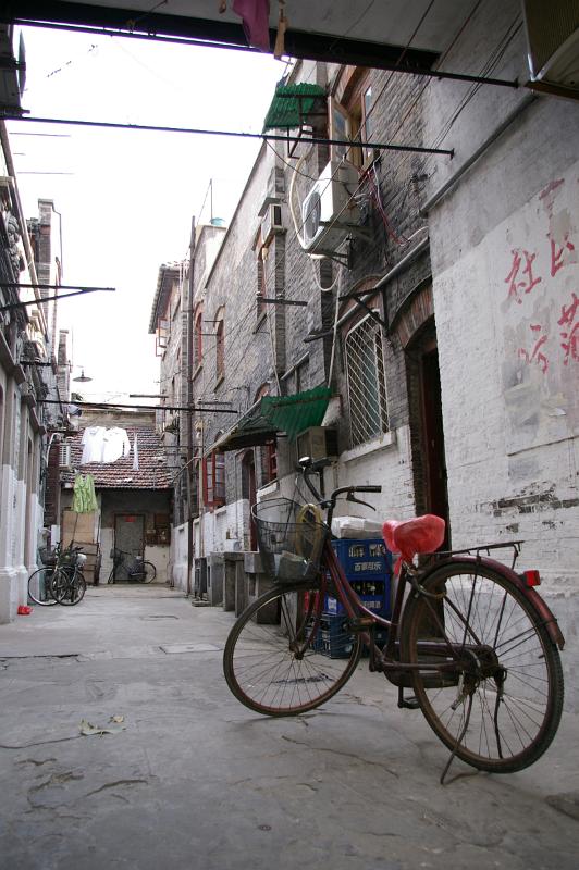 Old Bicycle at Vintage Compound Pathway with Ordinary Houses on Sides in China
