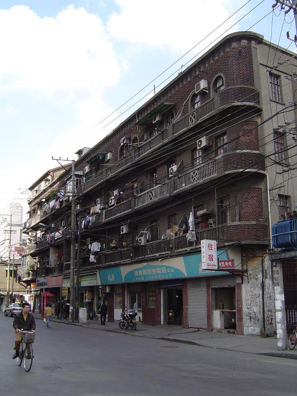Huge Vintage Building on Chinese Street Side, Captured with Bicycle Passing by