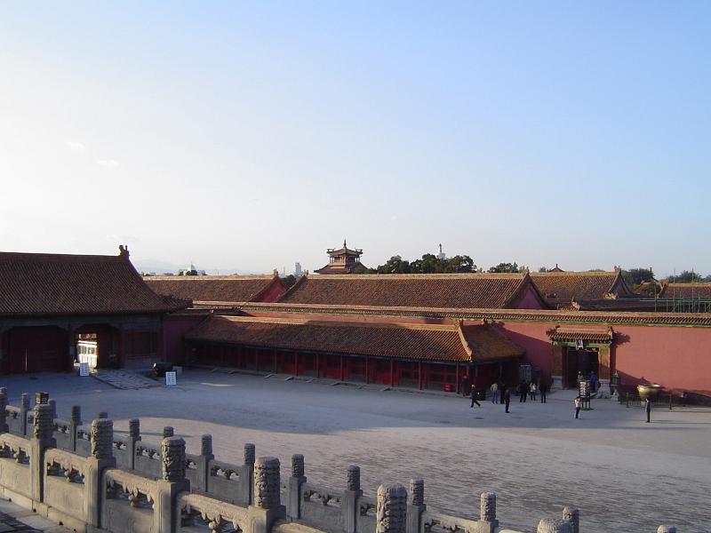 Tourists at Forbidden City Temple in China Random Tourists at Famous Forbidden City Temple, the Imperial Palace, Located in China. Captured on Lighter Blue Sky Background.