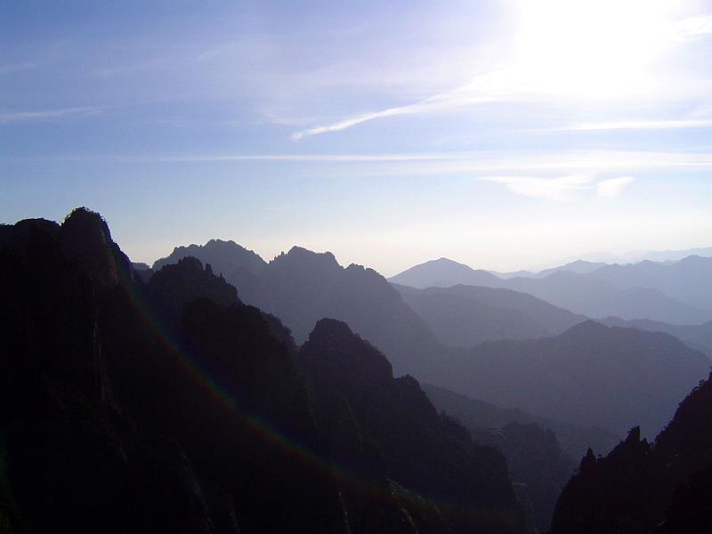 Yellow Mountain, China, vista with the Huangshan mountain range stretching away into the distance on a hazy sunny day