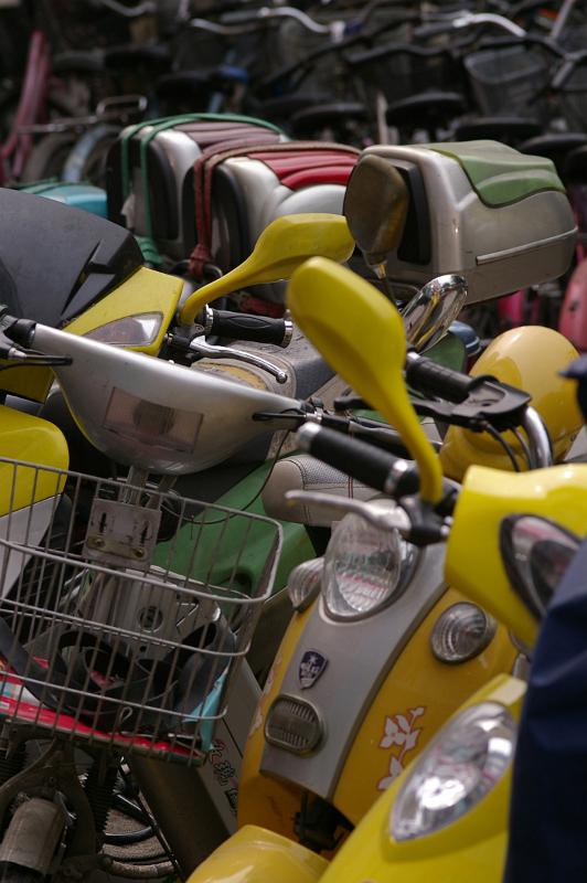 Close up Various Colored Motorbikes Parked at the Street in China.