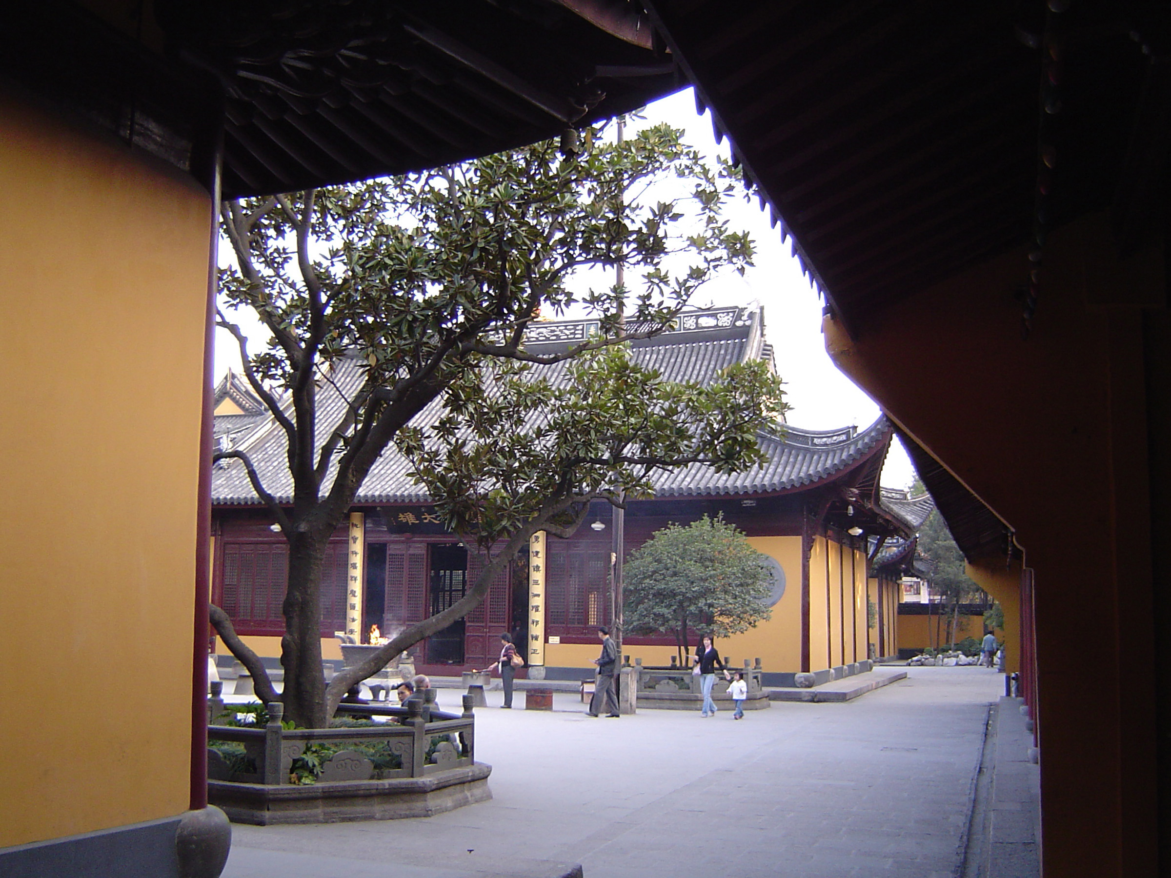 an image of Few Random Visitors at Beautiful Architectural Traditional Chinese Buddhist Temple Building