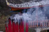 Burning incense sticks, or joss sticks, creating an aromatic smoke outside a Chinese temple