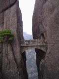 Ornate carved stone bridge, Yellow Mountains, China, spanning a narrow gap between two vertical rock faces