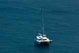 Luxury catamaran moored offshore in mid ocean with copyspace, high angle view