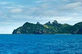 View across open blue ocean while cruising offshore of Yasawa Islands Fiji showing the rocky topography of these beautiful tropical islands