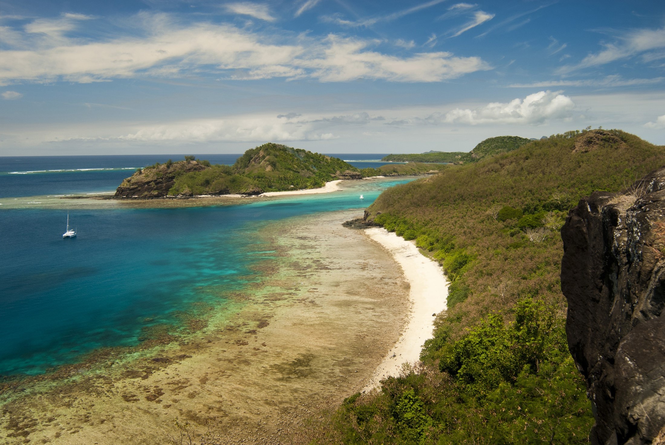 an image of View along a beach in Fiji, part of the Yasawas islands which are popular tourist destinations for their sandy beaches and traditional lifestyle