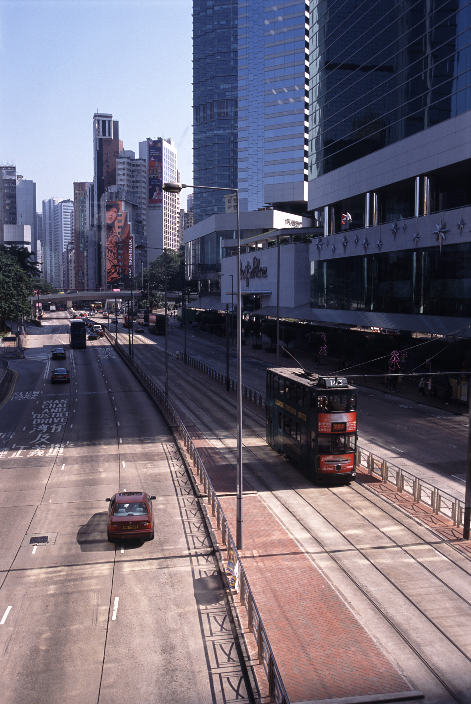 an image of No Traffic City Streets For Cars and Trams in Hong Kong China with High Rise Architectural Buildings on the Sides.
