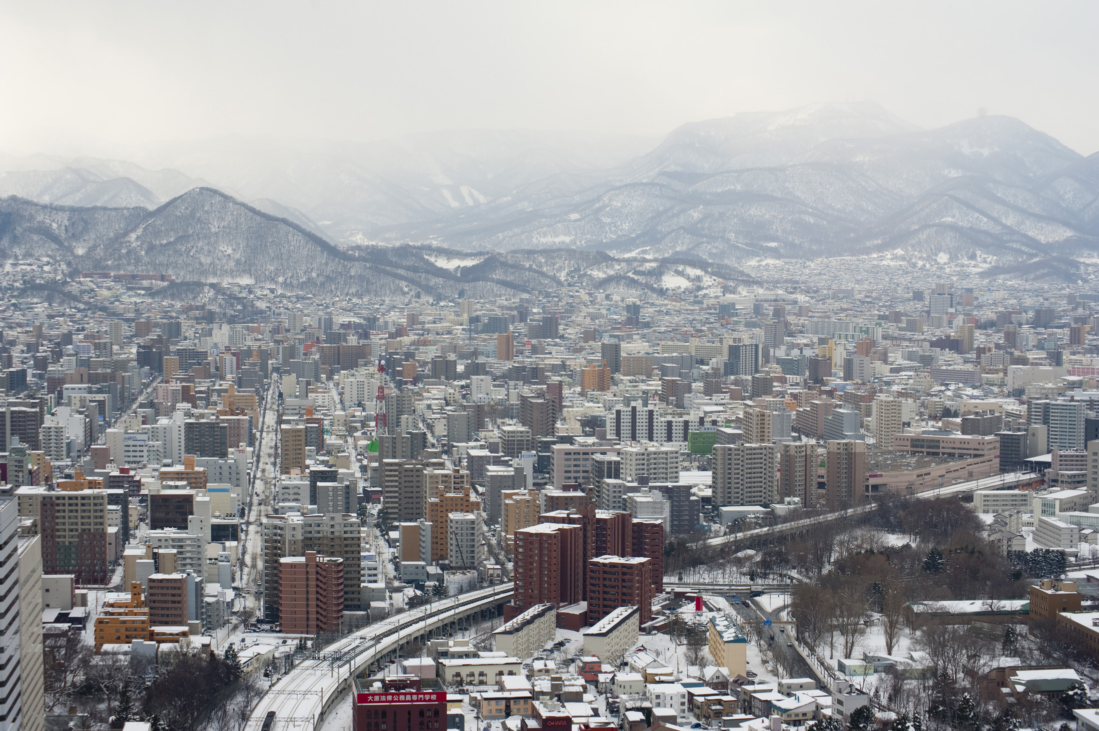 an image of Sapporo and surrounding mountains covered in snow, Hokkaido, Japan