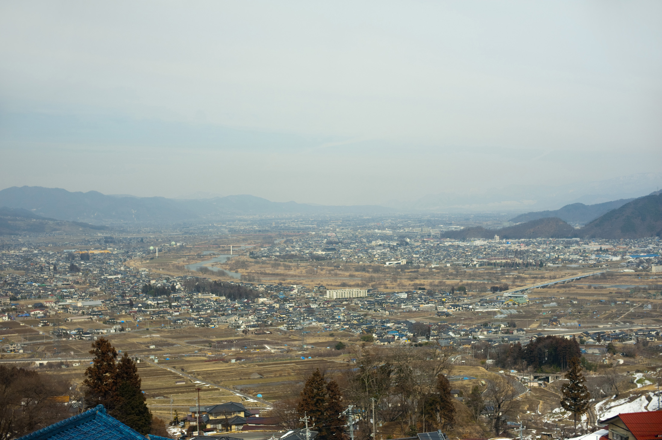 an image of A view of the city of nagano and surrounding mountains, Japan