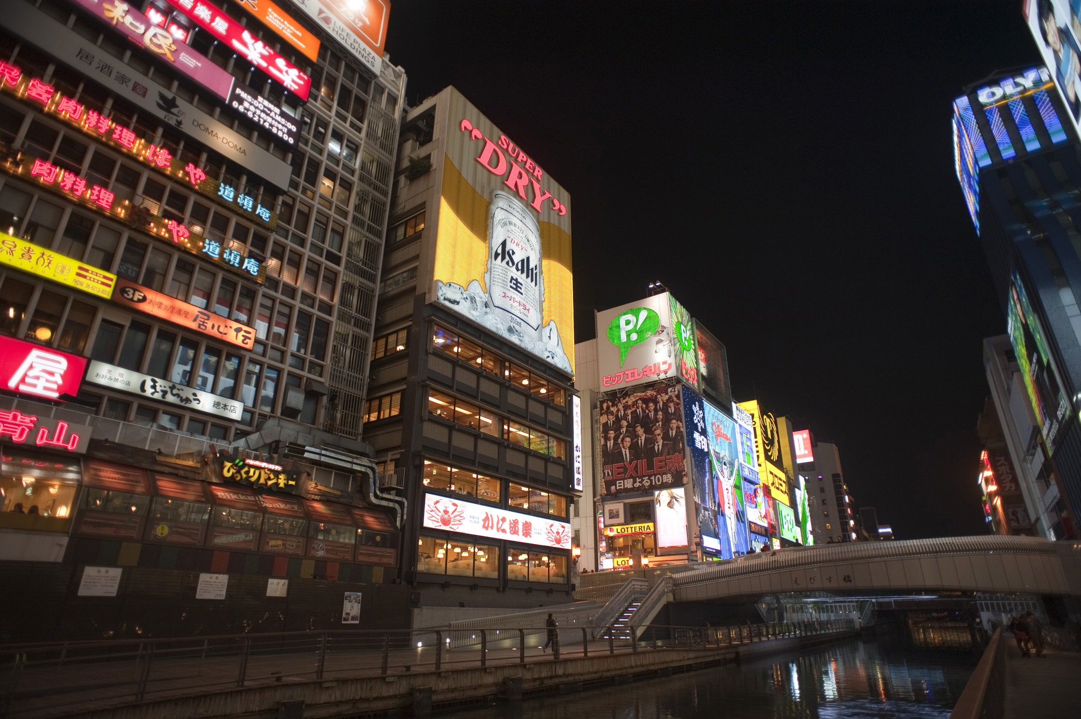 an image of Neon signs light up the night skyline in Dotonbori, Osaka, Japan