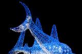 Blue illuminated shark sculpture outside Osaka aquarium