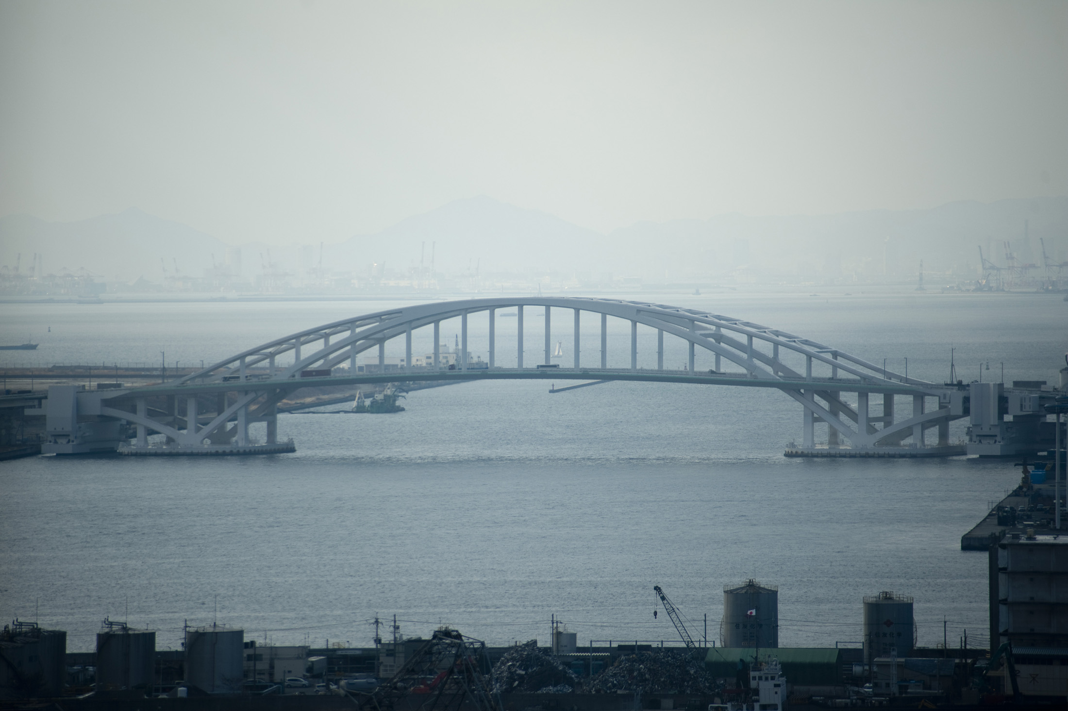 an image of View across osaka bay towards the Floating Openable Yumemai Bridge, Japan