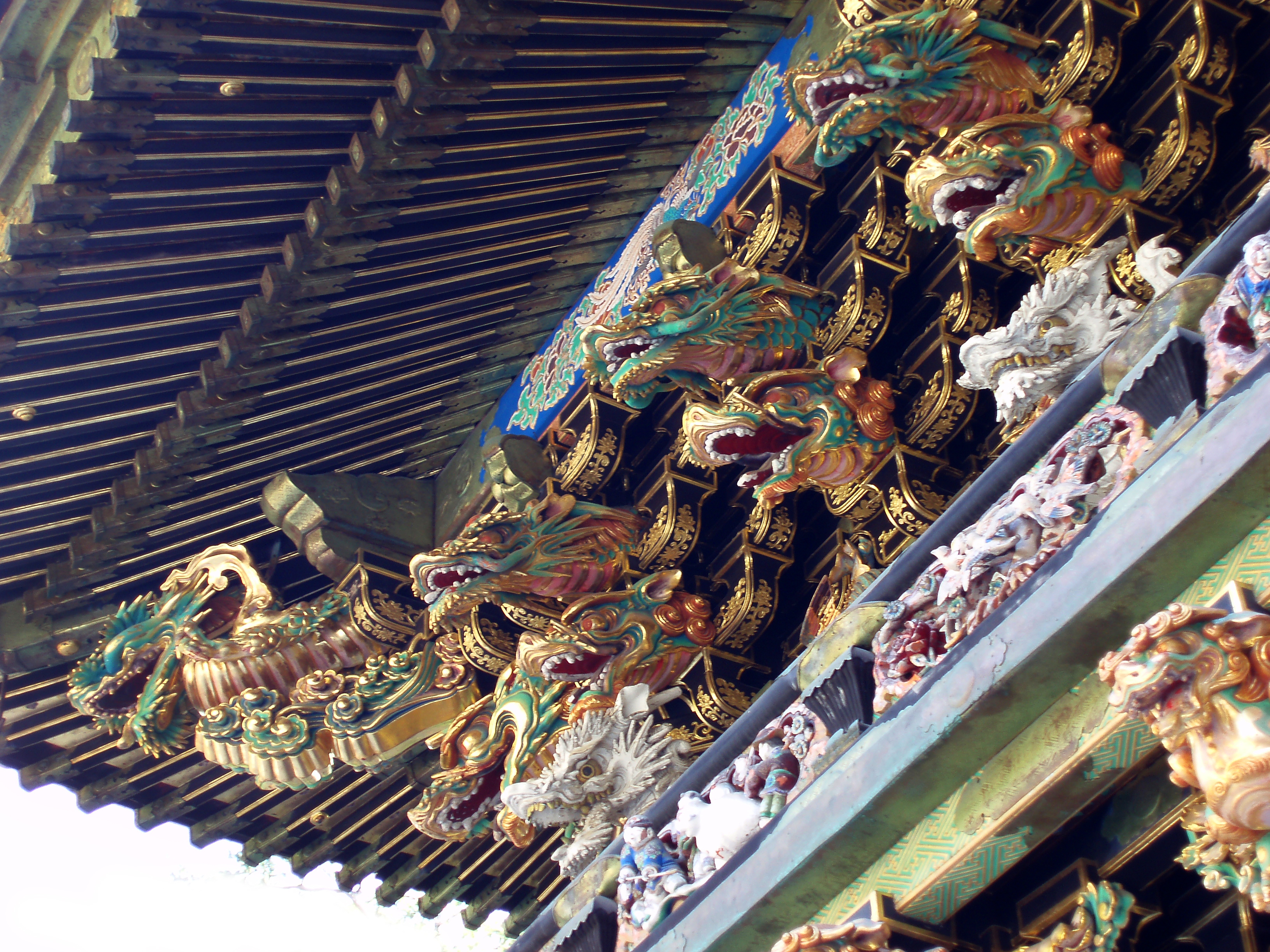 an image of beautiful ornate gold painted carvings high on the wall of a temple, nikko japan