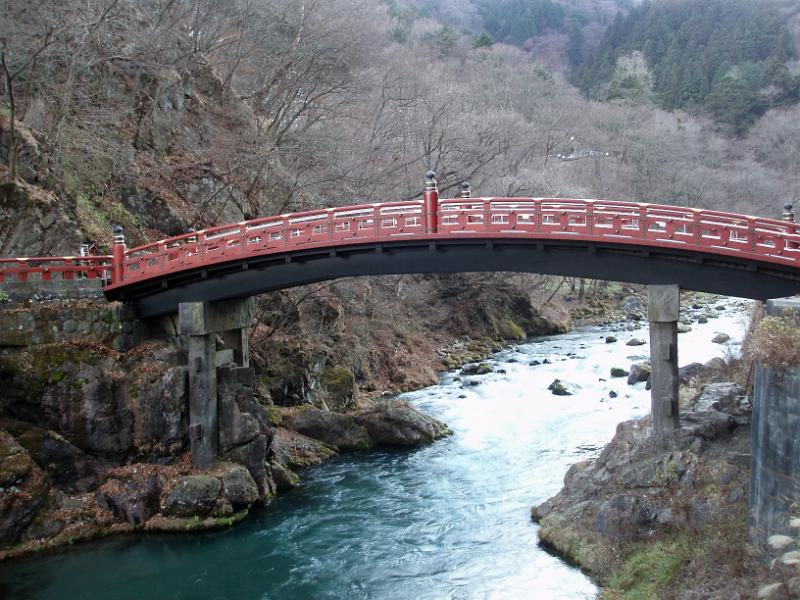 a red arching bridge spanning the Daiya River in nikko, japan