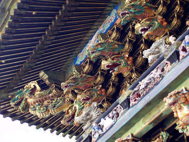 beautiful ornate gold painted carvings high on the wall of a temple, nikko japan