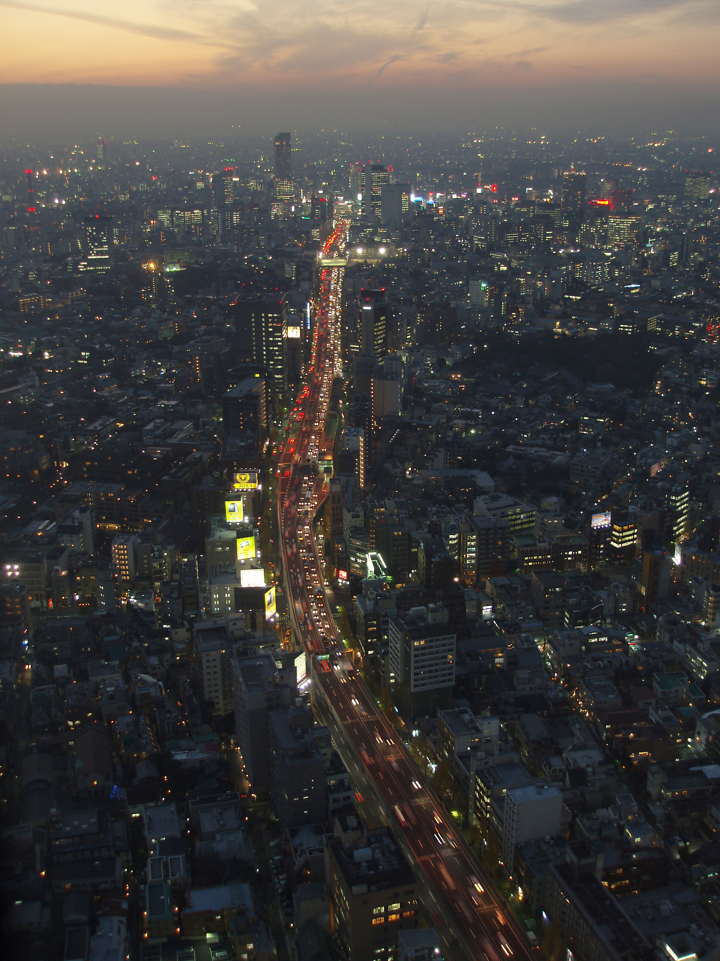 an image of busy streets of tokyo, an aerial view from high up at twilight