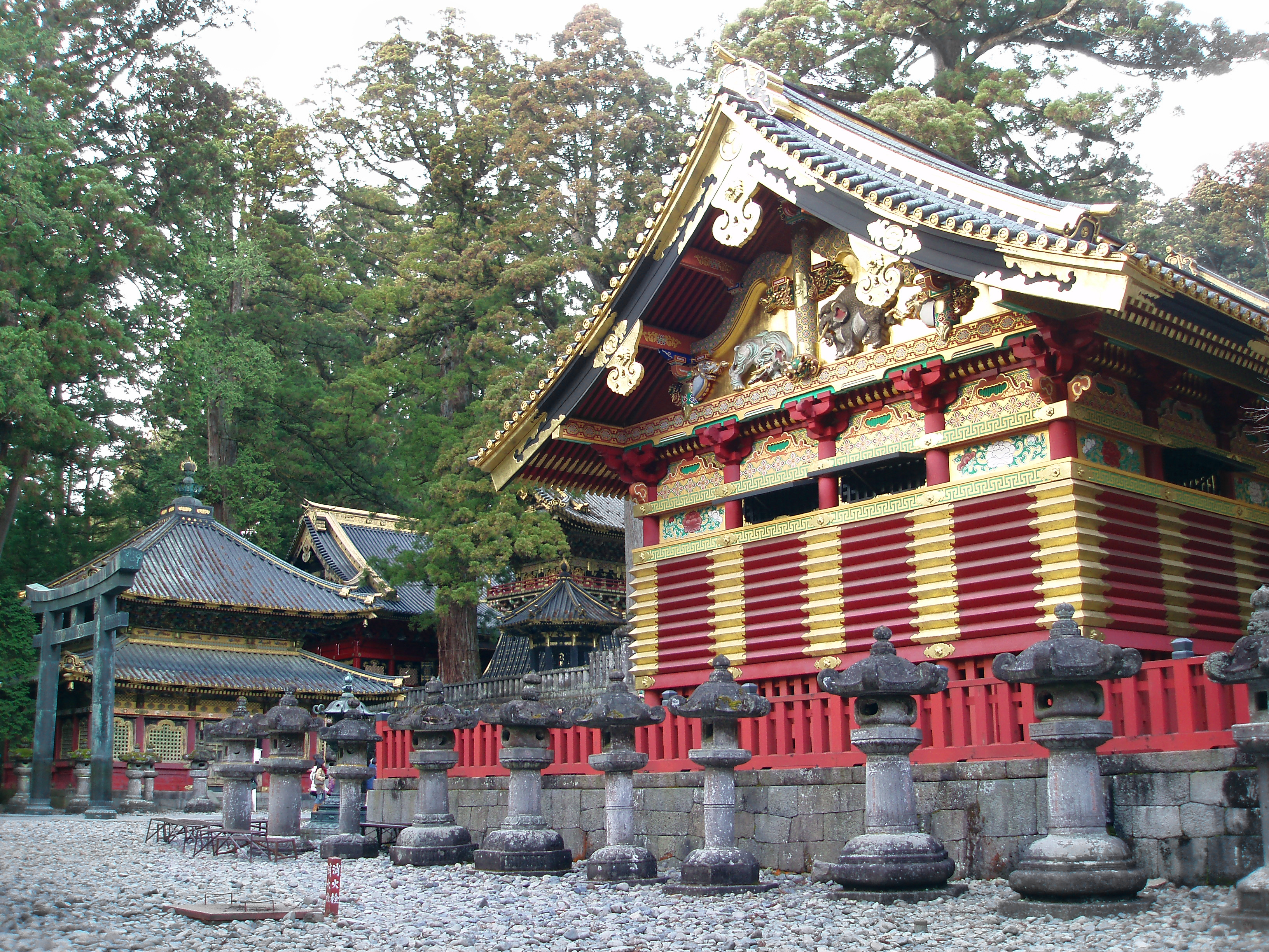 an image of gold and red painted temples buildings in the nikko world heritage temple complex