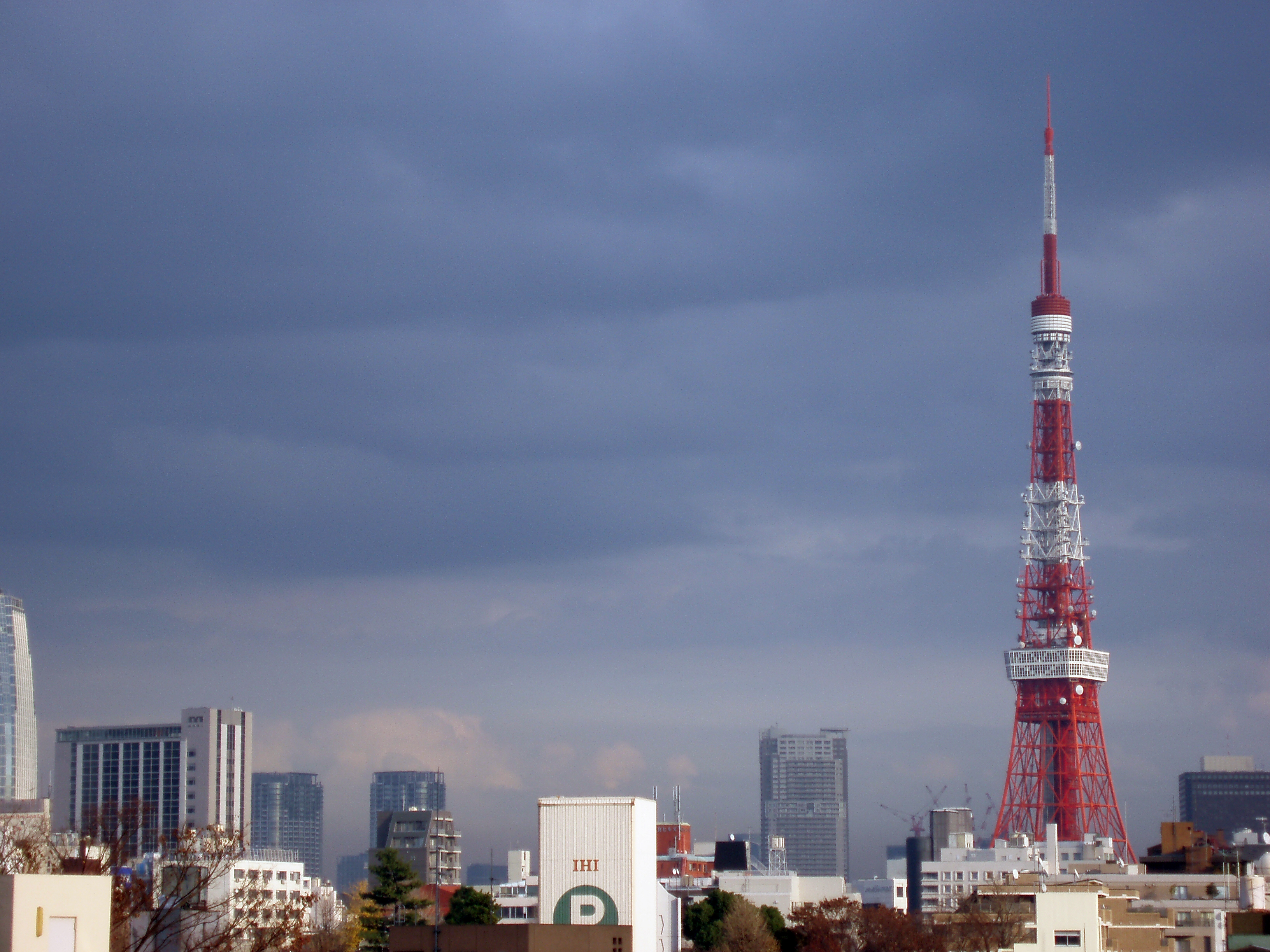 an image of stormy sky with the tokyo tv tower at other buildings, tokyo, japan