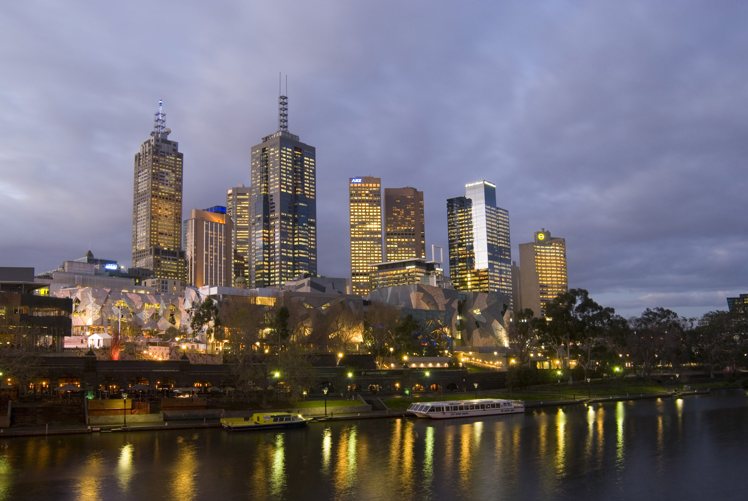 an image of A beautiful calm night on the Yarra River as city lights reflect from the nearby CBD of Melbourne.