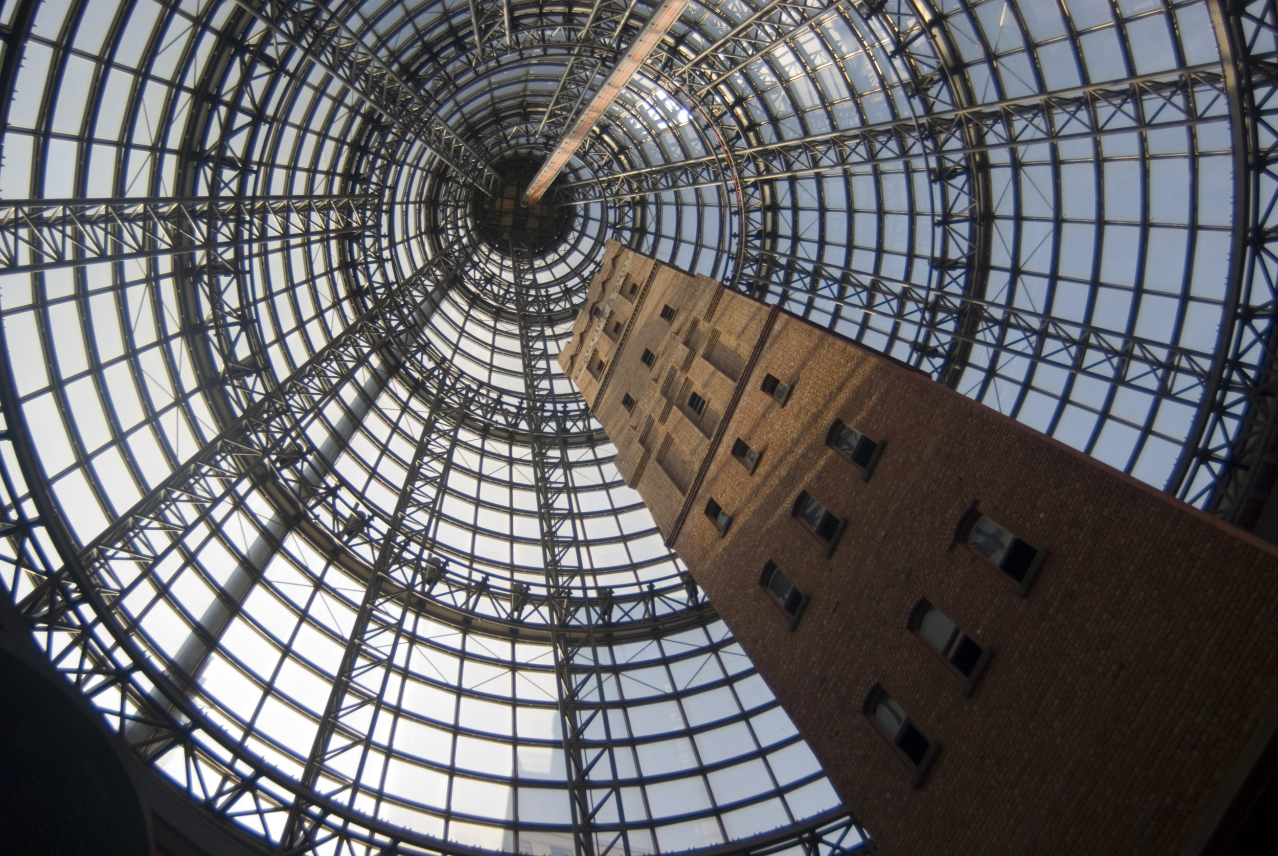 an image of A vertical, mesmerizing view of the glass cone, an architectural masterpiece in Melbourne Central shoppung centre, Australia.
