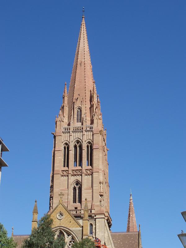 Architectural Exterior Peak Design of Melbourne Cathedral on Lighter Blue Sky Background.
