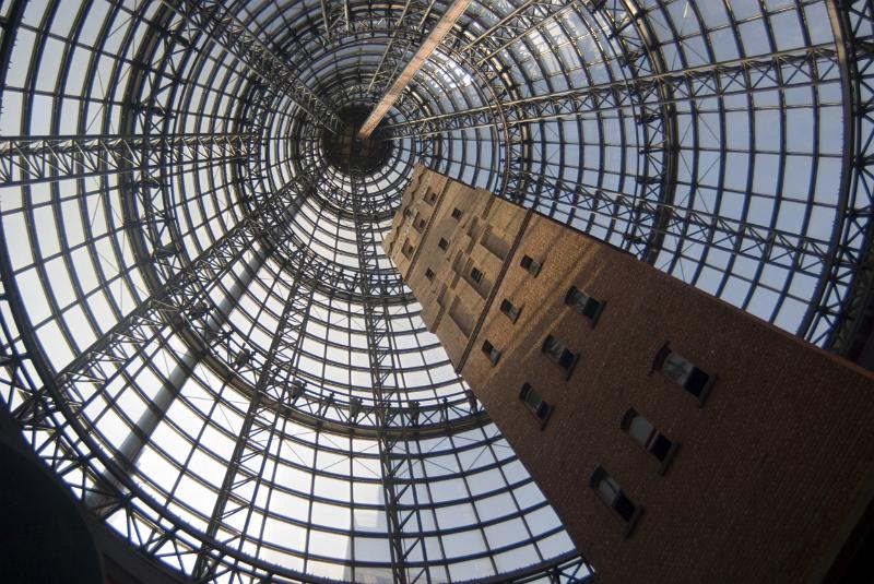 A vertical, mesmerizing view of the glass cone, an architectural masterpiece in Melbourne Central shoppung centre, Australia.