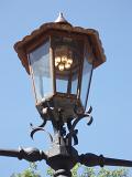 Close up Vintage Style Gas Powered Street Lamp in Melbourne on Light Blue Sky Background.