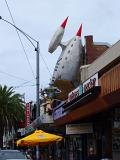 Huge Space Rocket with Muscular Man Sculpture on Street Cafe in St. Kilda, Melbourne.