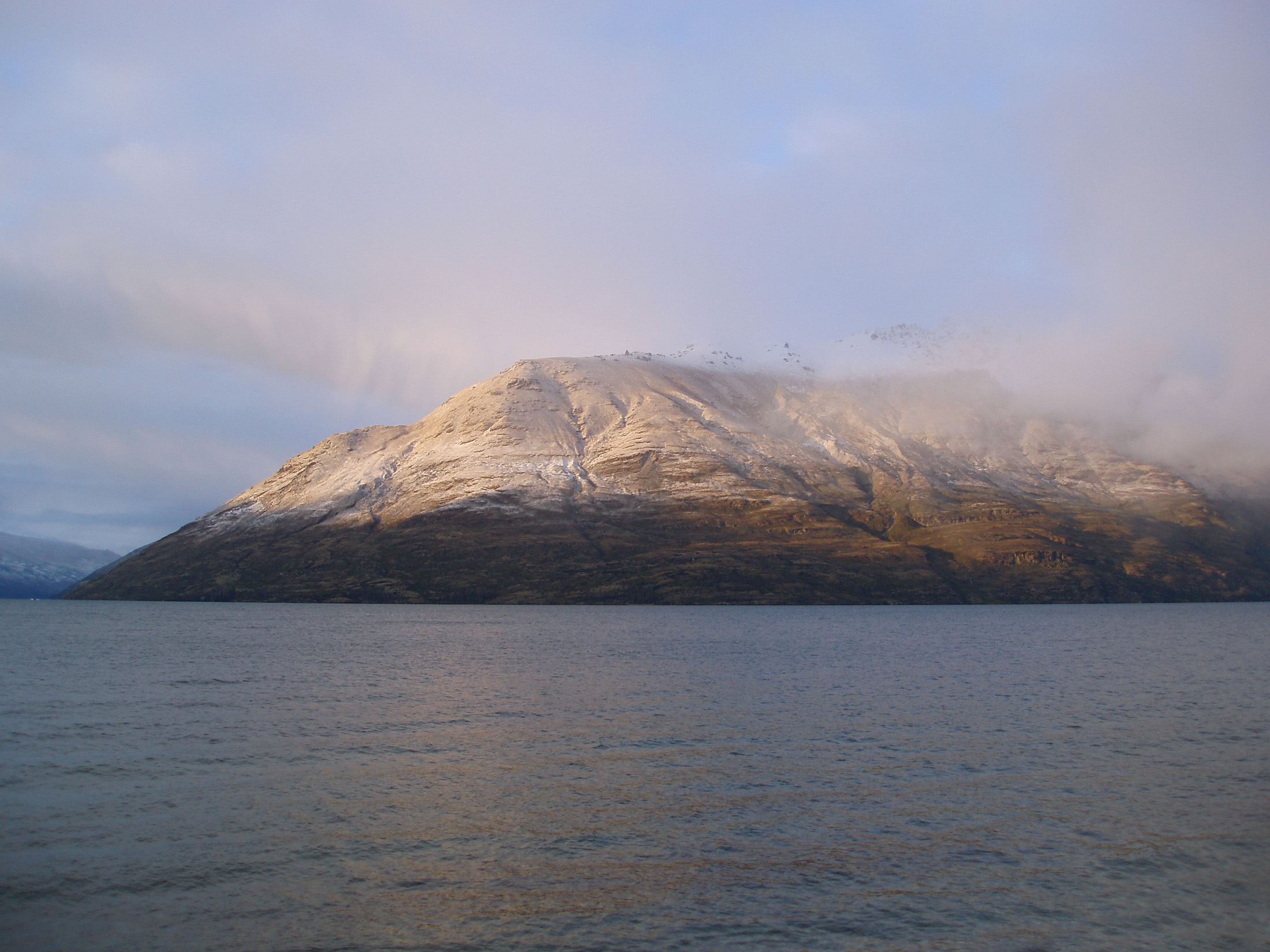 an image of view across lake wakatipu from queenstown newzealand in winter