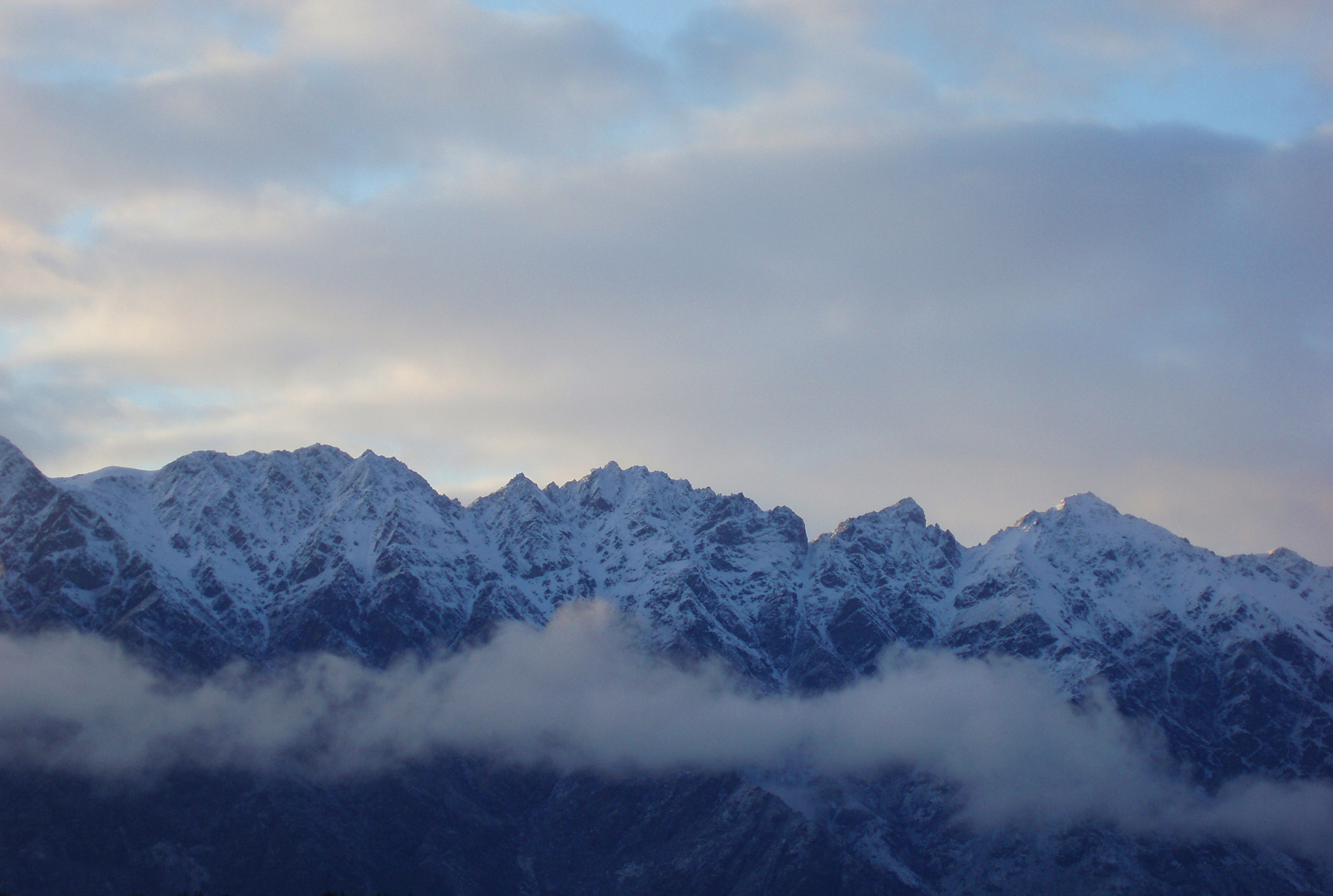 an image of jagged mountain panorama, the remarkables range in winter with a covering of snow