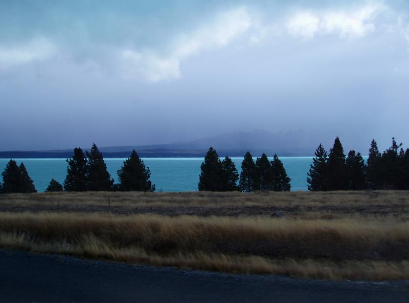 the blue waters of lake tekapo, mt cook hidden in the mist,