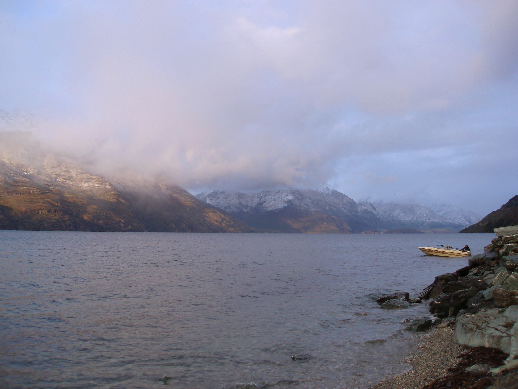 an image of a strom day over lake lake wakatipu, queenstown, new zealand,