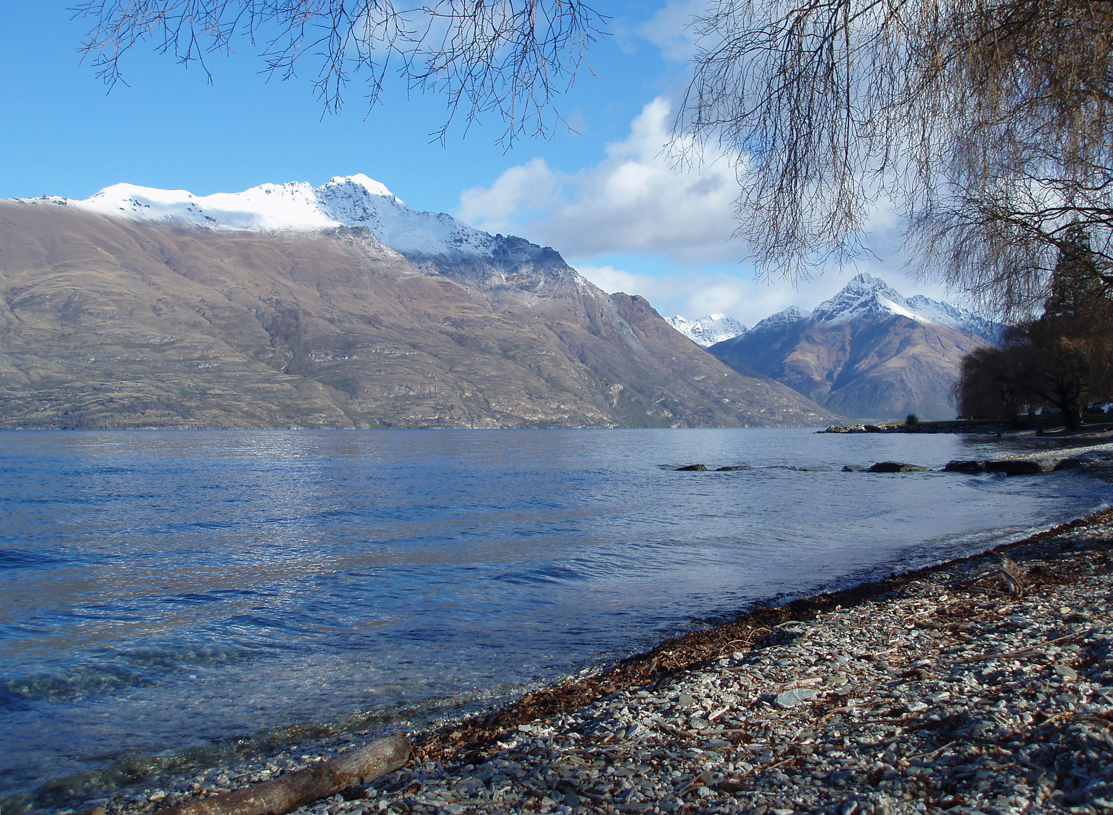 an image of serene waters lake seen from the shores of lake wakatipu in queenstown