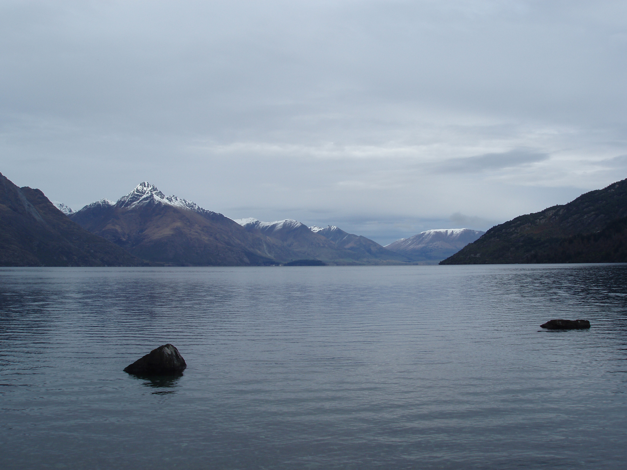 an image of serene view of lake wakatipu, on a grey day in  queenstown, newzealand