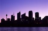 Sunset over the Sydney, Australia CBD with the skyscrapers silhouetted against a colorful purple sky at twilight