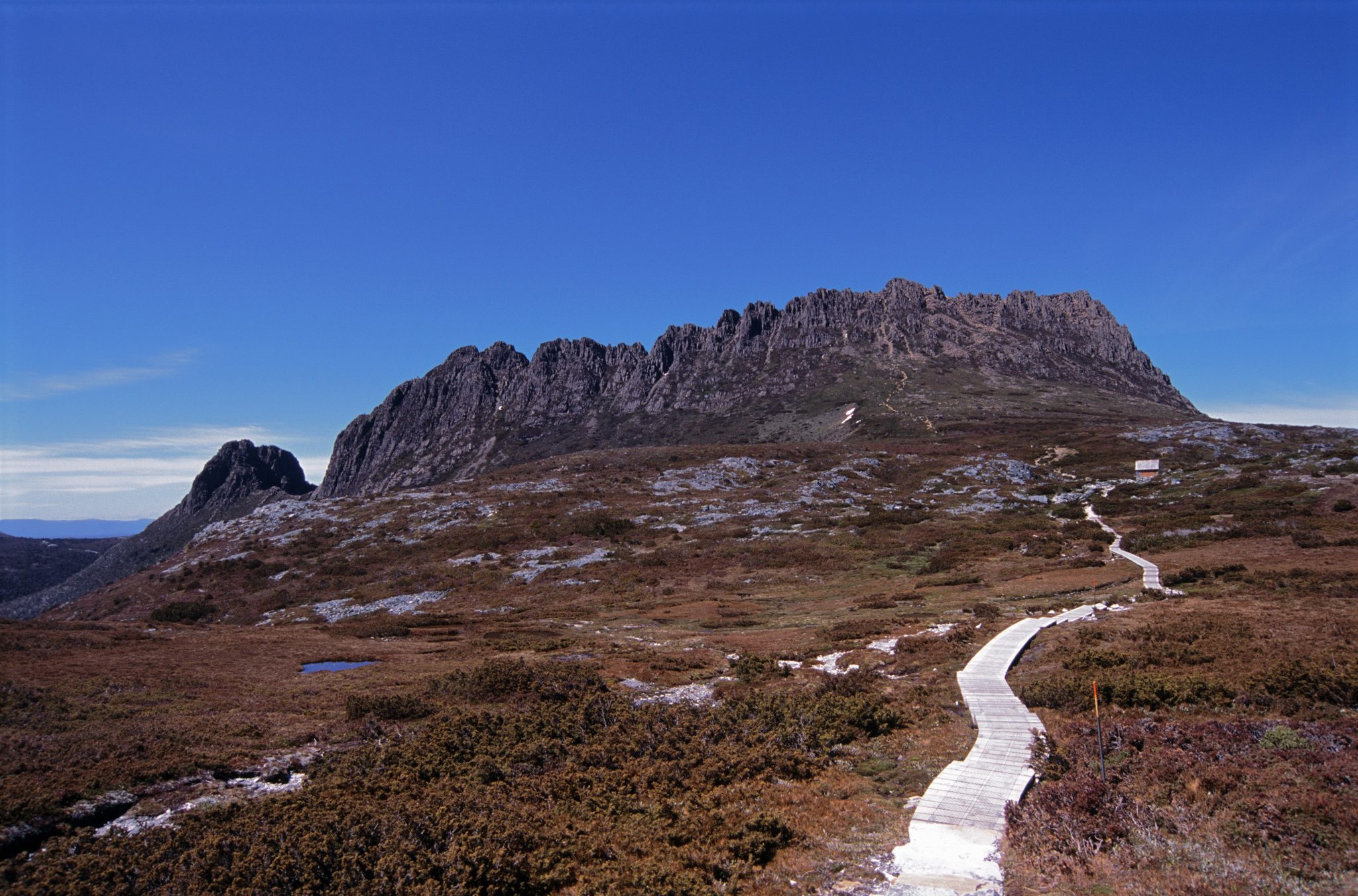 an image of Overland trail with a wooden boardwalk leading to Cradle Mountain, Tasmania in the highlands