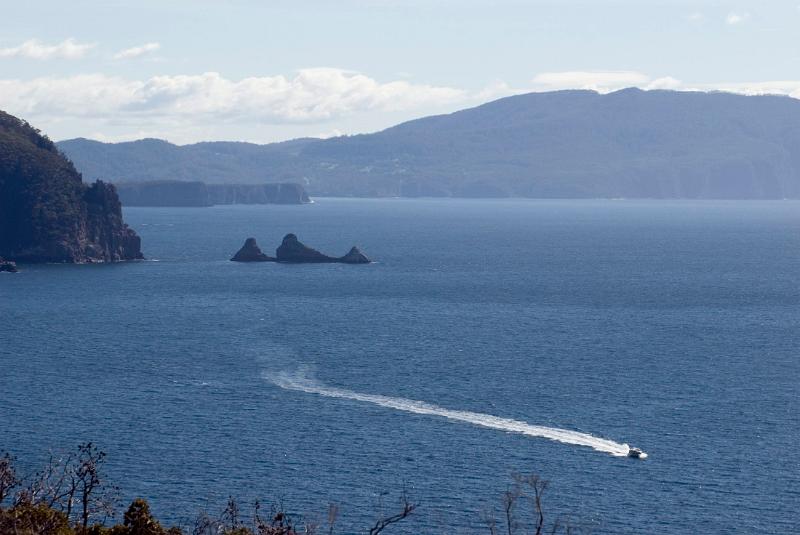 tasman peninsula ocean scene with a jetboat in the foreground