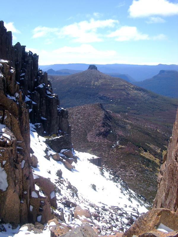 View from the highest mountain in Tasmania, Mount Ossa of the overland track crossing the mountains dusted with light snow