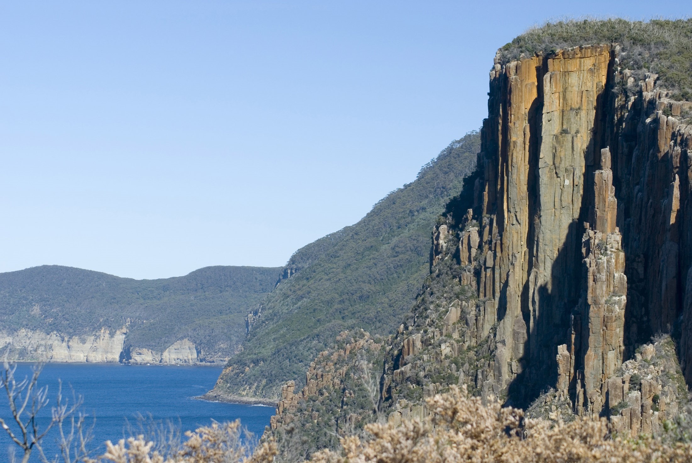 an image of rugged dolertite cliffs framing an impressive seascape on the tasman peninsula