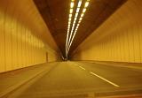 Road Level View of Road Tunnel with Yellow Lighting