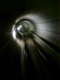 Motion background of a rail tunnel disappearing into the distance as a train travels through at speed in a travel, transport and commuting concept