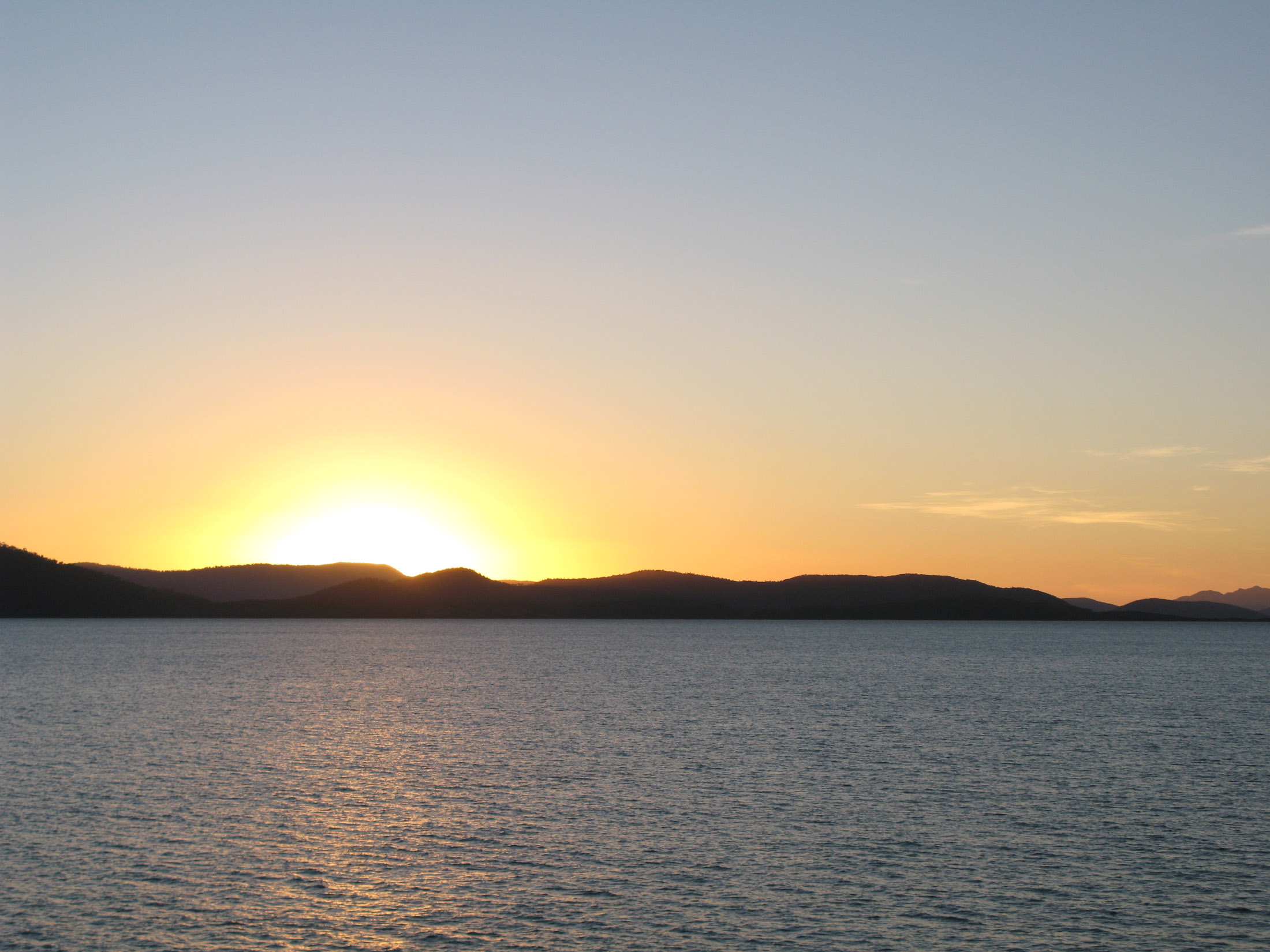 an image of sunset over tropical waters