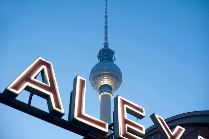 ther berlin fernsehturm tv tower and a neon sign at alexanderplatz