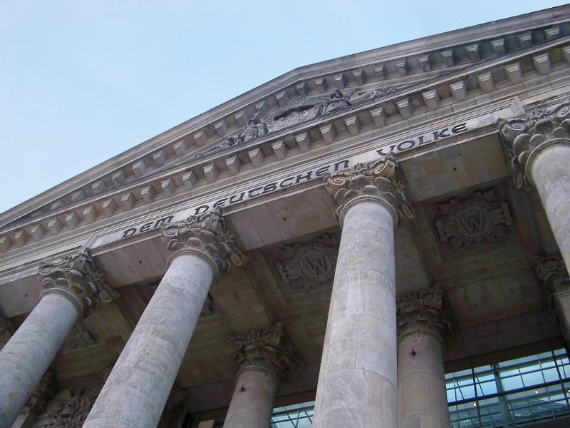 Front facade of the Reichstag Building in Berlin, Germany, showing the front portico and colonnade and inscription on the frieze