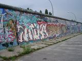 Section of the Berlin Wall in East Germany erected during the Cold War to separate the city covered in colorful urban art or graffiti
