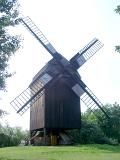Historic square wooden windmill with large sails in Berlin, now a museum