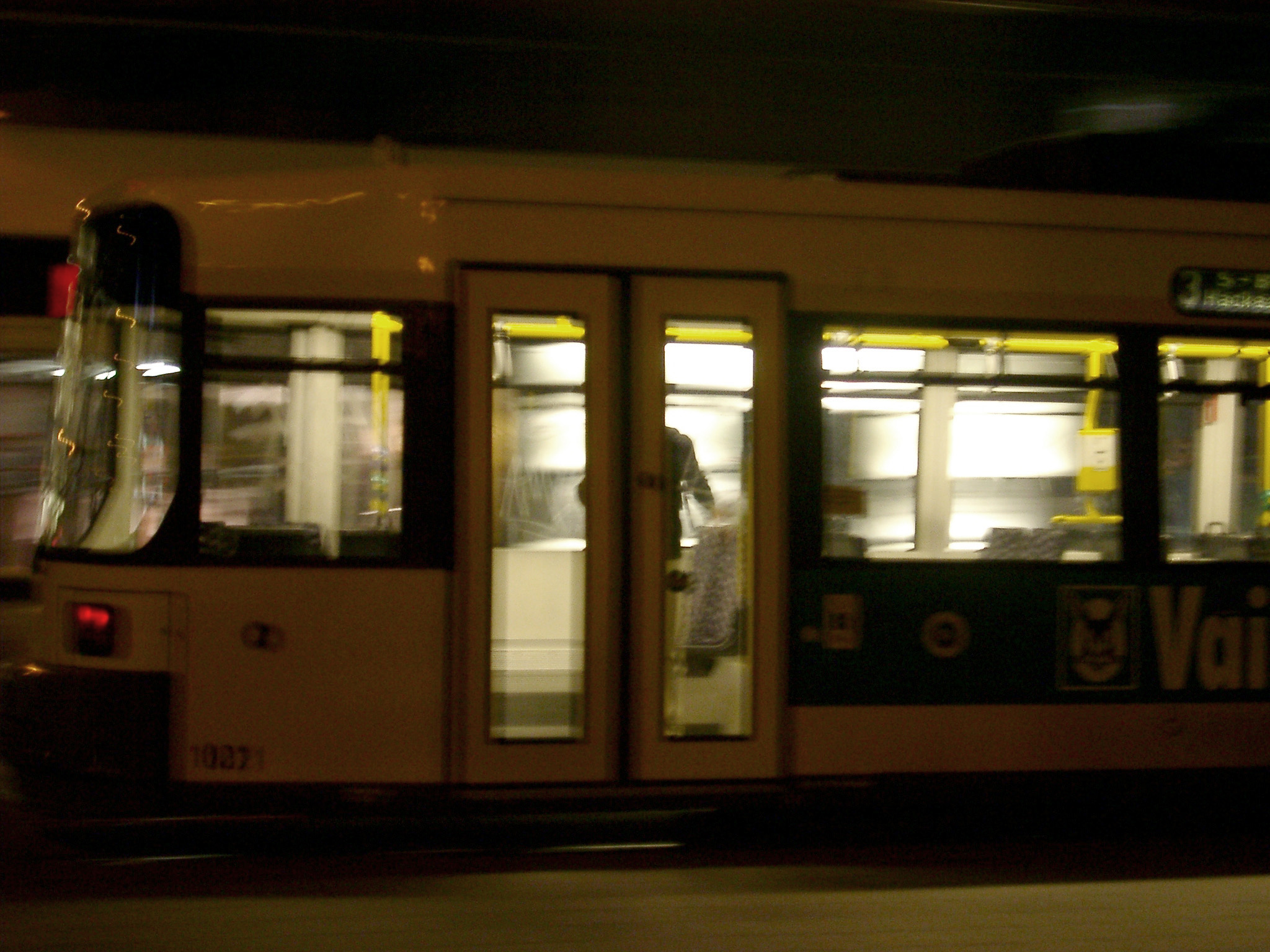 an image of Blurred Berlin Tram Public Transportation Traveling Fast at Night, Germany