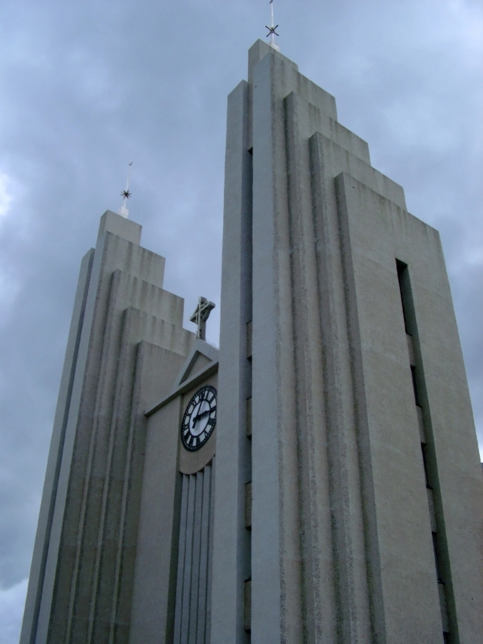 an image of Akureyrarkirkja, prominent Lutheran church with unusual architecture from Akureyri, under a cloudy sky, in northern Iceland